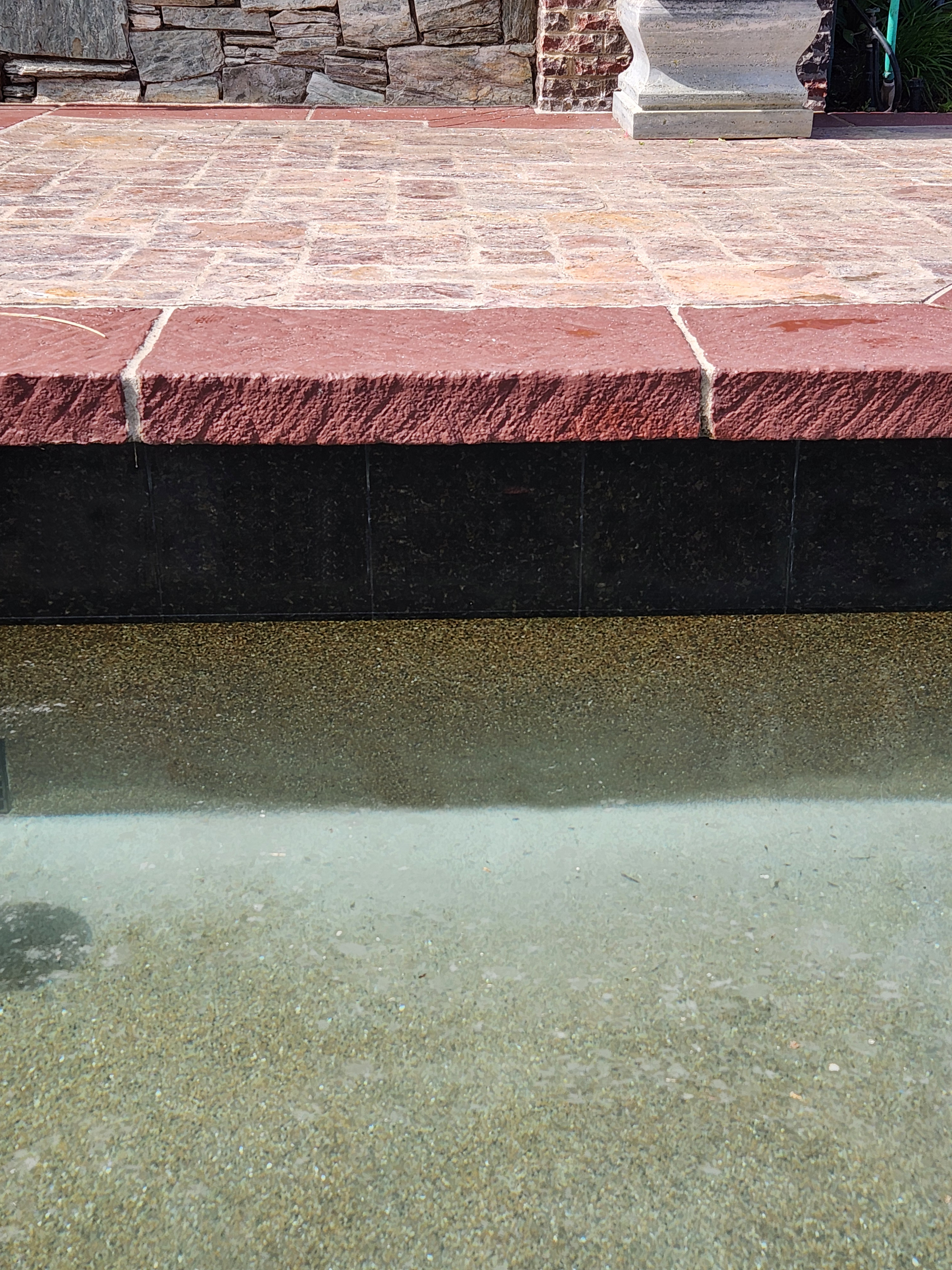 Same pool waterline tile after calcium removal — vibrant and clean